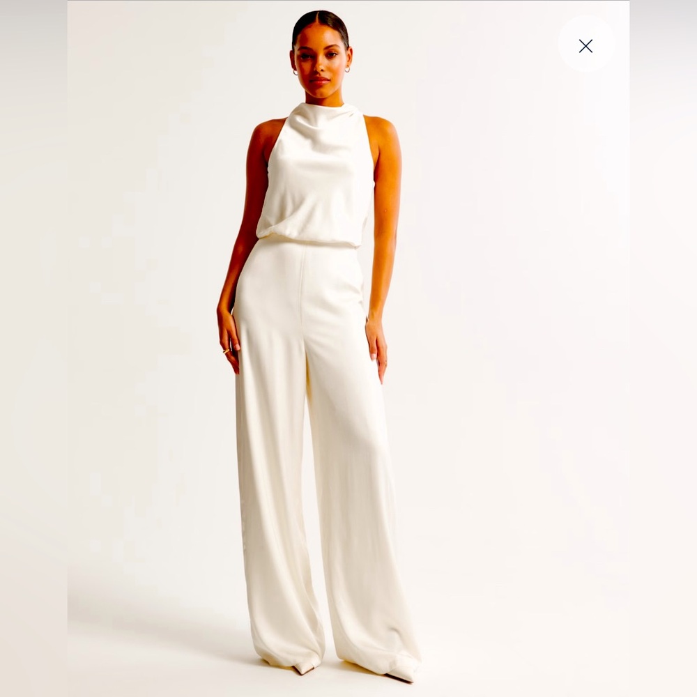 NWT, never worn, white high neck draped jumpsuit. Size M.